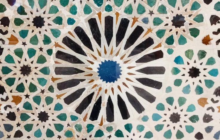 Islamic ornaments on the walls, floors and windows of the Alhambra, a historic palace and fortress in Granada, Spain, and a UNESCO World Heritage Site.