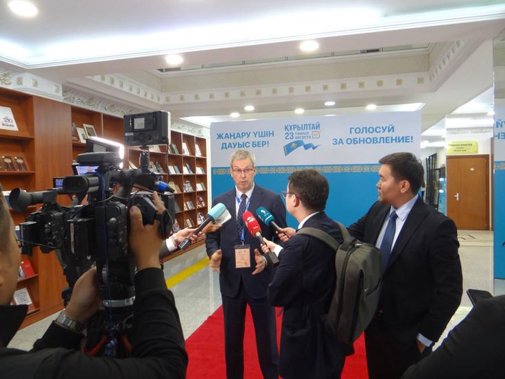 ODIHR mission head Amb. Vincent Piket speaks with reporters at a polling station in Astana.