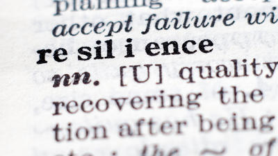 Dictionary close-up of the word "resilience," with pronunciation and part of speech.