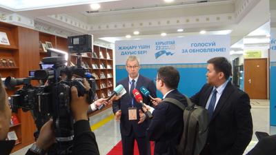 ODIHR mission head Amb. Vincent Piket speaks with reporters at a polling station in Astana.